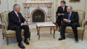 FILE PHOTO: Then Russian PM Putin and Exxon Mobil CEO Rex Tillerson attend meeting at Novo-Ogaryovo state residence outside Moscow
